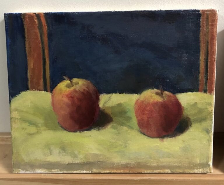 Two apples sitting on a chair